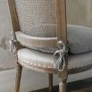 French-inspired dining chair with rattan-style back and removable seat cushion