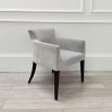 Sumptuous grey velvet chair with black, tapered back legs and pen mark on bottom of backrest 
