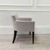 Sumptuous grey velvet chair with black, tapered back legs and pen mark on bottom of backrest 