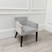 Sumptuous grey velvet chair with black, tapered back legs and pen mark on bottom of backrest 