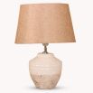 An elegant, terracotta table lamp with a natural, linen lampshade