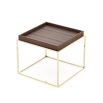 A luxurious side table with golden legs and a smoked matte eucalyptus wood tabletop