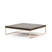 A chic modern coffee table with a copper frame and wooden surface 