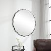 A stunning scalloped wall mirror by Uttermost