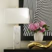 A glamorous solid marble table lamp with polished brass accents