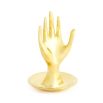 A solid brass hand-shaped ring holder