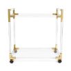 An understated glamorous bar cart made from clear acrylic, brushed brass and glass 