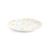 A luxurious dinner plate by Jonathan Adler made from porcelain with splatters of solid gold 