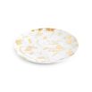 A luxurious dinner plate by Jonathan Adler made from porcelain with splatters of solid gold 