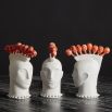 A white porcelain punk-inspired mohawk lollipop holder