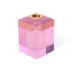 A luxuriously glamorous candleholder by Jonathan Adler with a solid pink acrylic block fitted with a solid brass corner candleholder