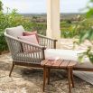 Striking outdoor chaise longue with woven rounded back and modern wooden frame