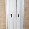 Rustic white cabinet with rattan style panelling on the doors