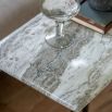 Square side table with a green marble top and a brass frame