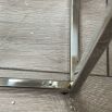 Polished stainless steel coffee table with tempered clear glass surface