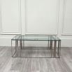 Polished stainless steel coffee table with tempered clear glass surface