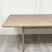 Wooden dining table with shaped underframe