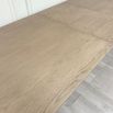 Wooden dining table with shaped underframe