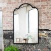 Ornate wall mirror with black iron frame and gentle arches 