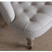 A sophisticated chair with a luxury linen upholstery and deep buttoned design 
