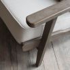 A stylish armchair with an ash wood frame and soft cream upholstery 