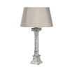 A luxurious antique aged stone pillar table lamp with a matching lampshade