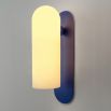 A luxury, large wall light by Schwung with a Santorini Blue finish and glass opal shade