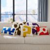 Square cushion with yellow abstract artwork