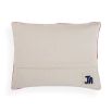 Rectangular cushion with red and white abstract artwork