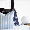A delicate light blue and white diamond striped cushion with white piping.