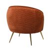 round burnt orange accent chair with brass-effect tapered legs 
