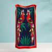 Dark blue beach towel with red border and two parrot design