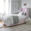 Grand luxury upholstered bed, with deep buttoned headboard, sharp wings and piping detail