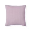 A chic cushion by Jonathan Adler made from linen with a blush colour and finished with 70s inspired patterns
