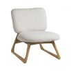 A luxurious faux shearling armchair with natural oak frame