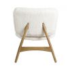 A luxurious faux shearling armchair with natural oak frame