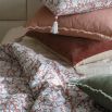 cosy quilt with floral details and tassels