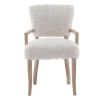The Winnie Dining Armchair, with its faux sheepskin upholstery and solid oak frame, adds Alpine elegance and comfort, featuring solid oak arms for added support.