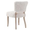 The Winnie Dining Chair, upholstered in faux sheepskin and set on a solid oak frame, brings Alpine charm and style to your dining room.