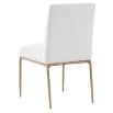 The Sloane Dining Chair, with its brass gold metal legs and off-white C0 fabric upholstery, effortlessly adds a chic mid-century modern touch to any dining space.