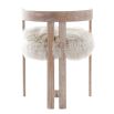 The Baaarb Dining Chair, with its real cream sheepskin seat and solid oak frame, exudes luxurious contemporary style and texture, making it a striking addition to any dining space.