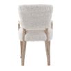 The Winnie Dining Armchair, with its faux sheepskin upholstery and solid oak frame, adds Alpine elegance and comfort, featuring solid oak arms for added support.