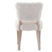 The Winnie Dining Chair, upholstered in faux sheepskin and set on a solid oak frame, brings Alpine charm and style to your dining room.