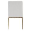 The Sloane Dining Chair, with its brass gold metal legs and off-white C0 fabric upholstery, effortlessly adds a chic mid-century modern touch to any dining space.
