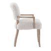 The Winnie Dining Armchair, with its faux sheepskin upholstery and solid oak frame, adds Alpine elegance and comfort, featuring solid oak arms for added support.
