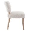The Winnie Dining Chair, upholstered in faux sheepskin and set on a solid oak frame, brings Alpine charm and style to your dining room.