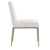 The Sloane Dining Chair, with its brass gold metal legs and off-white C0 fabric upholstery, effortlessly adds a chic mid-century modern touch to any dining space.