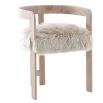 The Baaarb Dining Chair, with its real cream sheepskin seat and solid oak frame, exudes luxurious contemporary style and texture, making it a striking addition to any dining space.