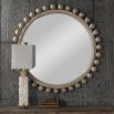 Natural finished round mirror with wooden spheres surrounding the border