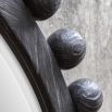 Sculptured ebony wooden framed mirror with surrounding spheres